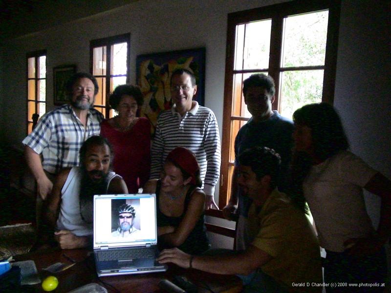 Aronson Family and friends looking at digital photo of Steve