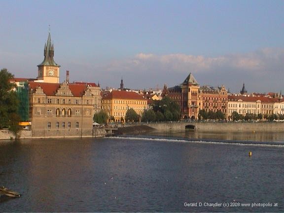 Weir on Vltava River, with view of right bank riverfront buildings near Old Town